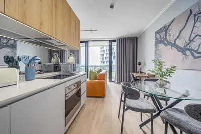 a kitchen with a glass table and a dining room at Skyline Serenity in Midrand