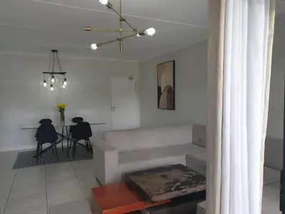 a living room with a couch and a table at Nompu b&b in Pretoria