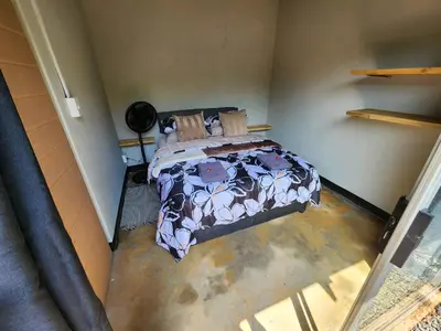 a bedroom with a bed in a room at Hartbeest Bush Stay #30 in Hartbeespoort
