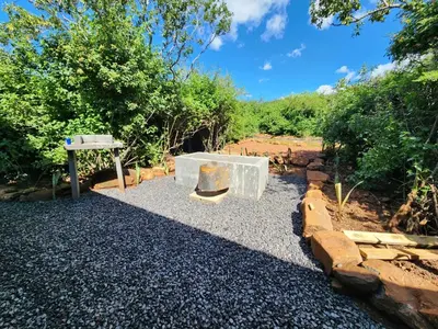 a stone bench sitting on top of a pile of gravel at Hartbeest Bush Stay #29 in Hartbeespoort