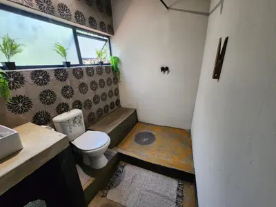 a small bathroom with a toilet and a window at Hartbeest Bush Stay #27 in Hartbeespoort