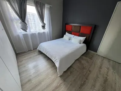 a bedroom with a white bed and a window at Spacious Midrand 3 Bedroom Near Gallagher, MOA & Gautrain in Midrand