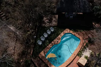 an overhead view of a swimming pool with a house at Thaba View Luxury Tent in Hartbeespoort