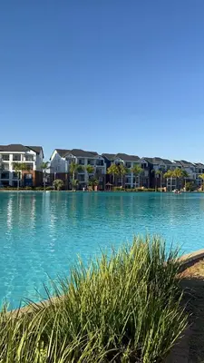 a large body of water with buildings in the background at The Dream Escape At The Blyde - One Bedroom Apartment in Pretoria