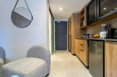 a kitchen with two chairs and a counter top at #AlimamaSpaces Rob's Menlyn Maine in Pretoria