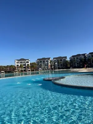 a large pool with blue water in front of some buildings at The Dream Escape At The Blyde - 2 Bedroom Apartment in Pretoria