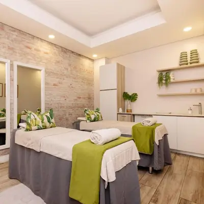 a bedroom with two beds with green and white pillows at The Dream Escape At The Blyde - Lagoon Facing 3 Bedroom Apartment in Pretoria