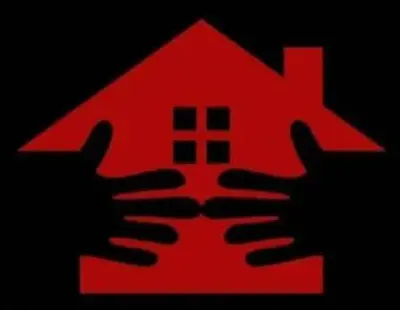a red house with two hands holding up it at Kiba guest house in Marble Hall