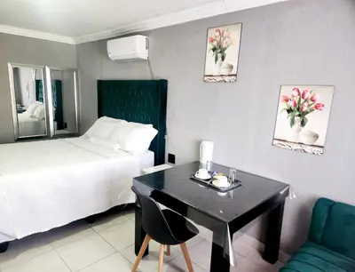 a hotel room with a desk and a bed at Kiba guest house