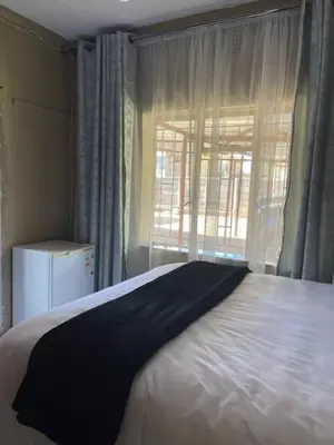 a bedroom with a large bed and a window at Guest house at 17 Arnot