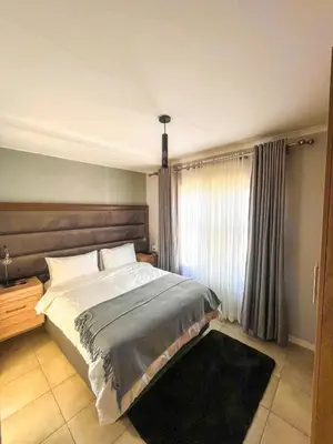 a bedroom with a large bed and a window at Chillasclub BNB-SAFUBI VIEWS in Nelspruit