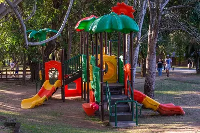a playground in a park with colorful playground equipment at Kruger Park Lodge Unit No. 509 in Hazyview