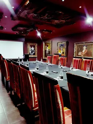 a conference room with a long table and chairs at Fusion Boutique Hotel in Polokwane