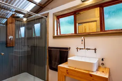 a bathroom with a sink and a shower at AfriCamps at Mackers in Hazyview