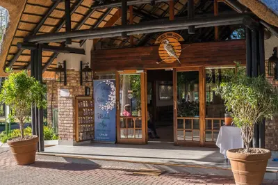 a building with an open door with potted plants at Kruger Park Lodge Unit No. 611 in Hazyview