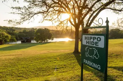 a sign for a hippo ride next to a tree at Kruger Park Lodge Unit No. 239 in Hazyview