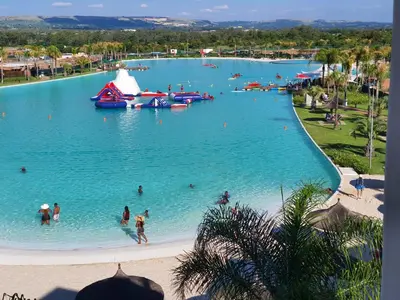 a large pool with people in the water at a resort at The Blyde in Pretoria