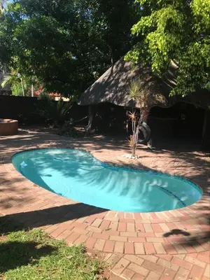 a small blue swimming pool on a brick yard at Villa Danamara in Phalaborwa