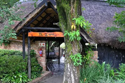a sign on a tree in front of a building at Kruger Park Lodge Unit No. 610A in Hazyview
