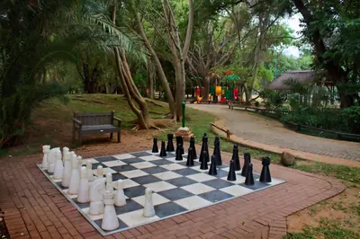 a chess board on a brick path in a park at Kruger Park Lodge Unit No. 610A in Hazyview