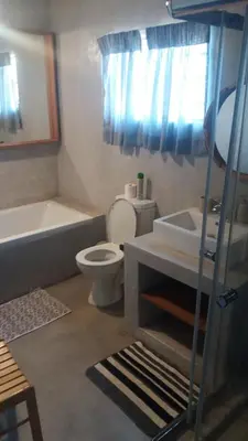 a bathroom with a toilet and a tub and a sink at Confortable farmhouse in Limpopo Province in Lephalale