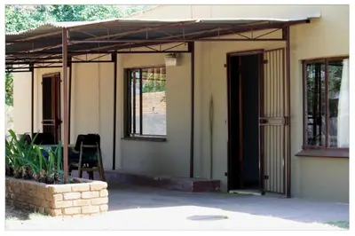 a porch of a house with an open door at Comfy room with dstv and aircon in convenient location in Lephalale