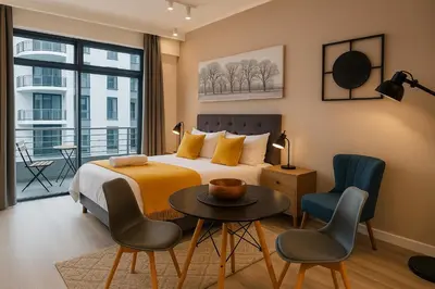 a bedroom with a bed and a table and chairs at Menlyn Apartment - Studio in Pretoria