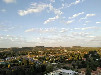 an aerial view of a small town with mountains at Menlyn Residence in Pretoria