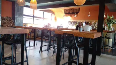 a bar with wooden bar stools in a restaurant at 396 The Blyde Crystal Clear Lagoon 2 Bedroom Penthouse Apartment in Pretoria