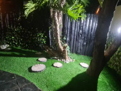 a garden with rocks and a fence at Cozy Cabin in Midrand