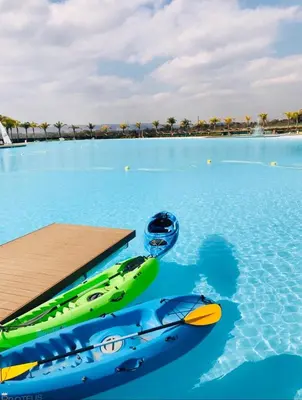 a swimming pool with two canoes in the water at The Blyde Riverwalk Estate, Crystal Lagoon, Pretoria east in Pretoria