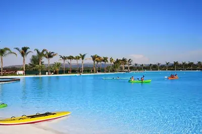 a large swimming pool with people on kayaks in the water at Insaka 3 The Blyde Lagoon Experience in Pretoria
