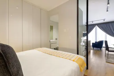 a bedroom with a bed and a desk and a chair at Alimama Spaces: The Manson's Ellipse in Midrand