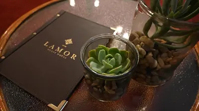a table with a vase with a plant on it at LUXURY FAMILY EN-SUITE ROOM @ 4 STAR GUEST HOUSE in Middelburg