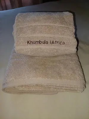 a towel with the words kumbucha kirribilli kirribilli at Khumbula iAfrica 2 in Marloth Park