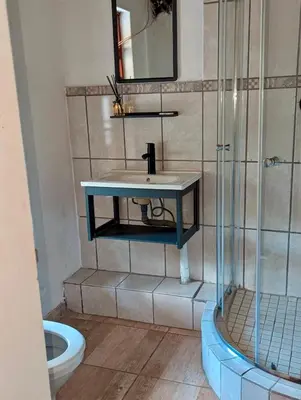 a bathroom with a sink and a shower at Goldpot Faerie Glen near Sun Bet Arena in Pretoria