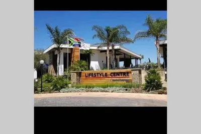 a house with a museum centre sign in front of it at The Blyde Silverlakes in Boschkop