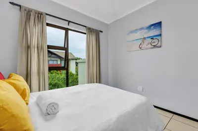 a bedroom with a white bed and a window at Smartz Apartment 76 in Midrand