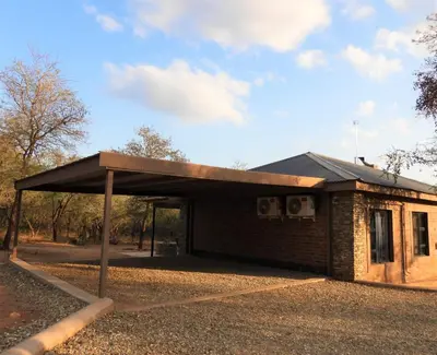 a building with a roof on the side of it at Locust Retreat in Marloth Park in Marloth Park