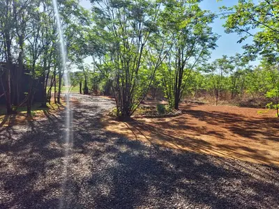 a fire hydrant spraying water in a field with trees at Vulture's View 8 in Hartbeespoort
