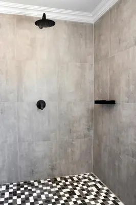 a bathroom with a black and white checkered floor at Woman Era Guest House in Midrand
