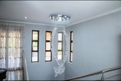 a chandelier hanging from the ceiling in a room at TINDLOVU GUESTHOUSE in Nelspruit