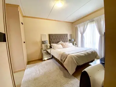 a bedroom with a bed and a large window at Siena Sun Luxury Suites in Erand