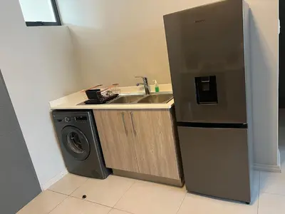 a kitchen with a sink and a washing machine at Mellow-Suites Apartments - 31 - WIFI and Netflix in Midrand
