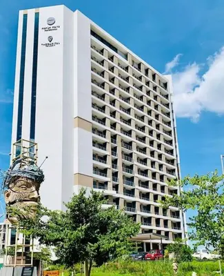 a large white building with a sign on it at Luxury 1 bedroom apartment in vibrant Menlyn Maine in Pretoria