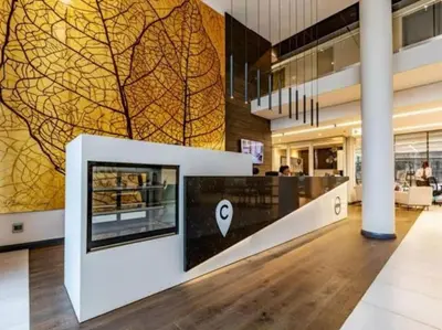 a lobby with a wall with a picture of a tree on it at Luxury 1 bedroom apartment in vibrant Menlyn Maine in Pretoria