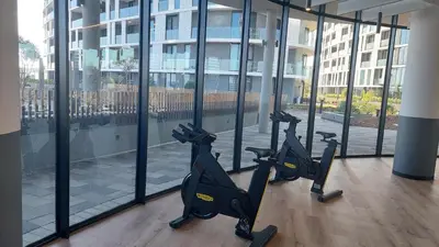 a gym with tread machines in front of a building at Keza Cove at Waterfall Ellipse in Midrand